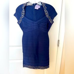 Herve Leger blue form fitting dress with silver and gold detailing.